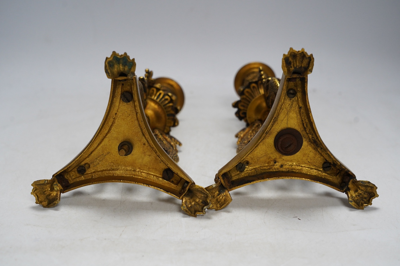 A pair of Empire style ormolu candlesticks, 20cm. Condition - fair to good